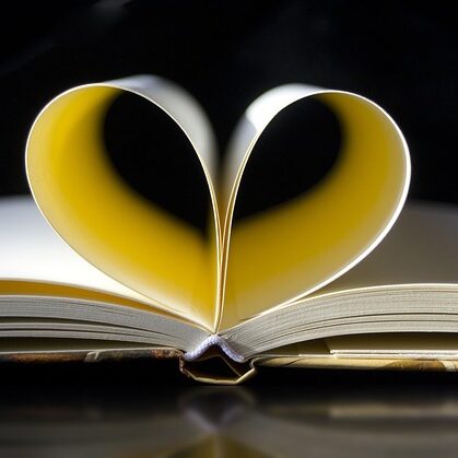 pages of a notebook curled in a heart